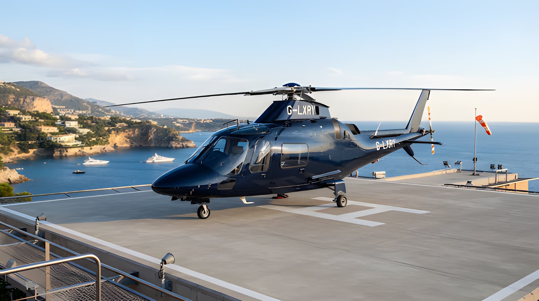 Dark helicopter parked on a coastal helipad